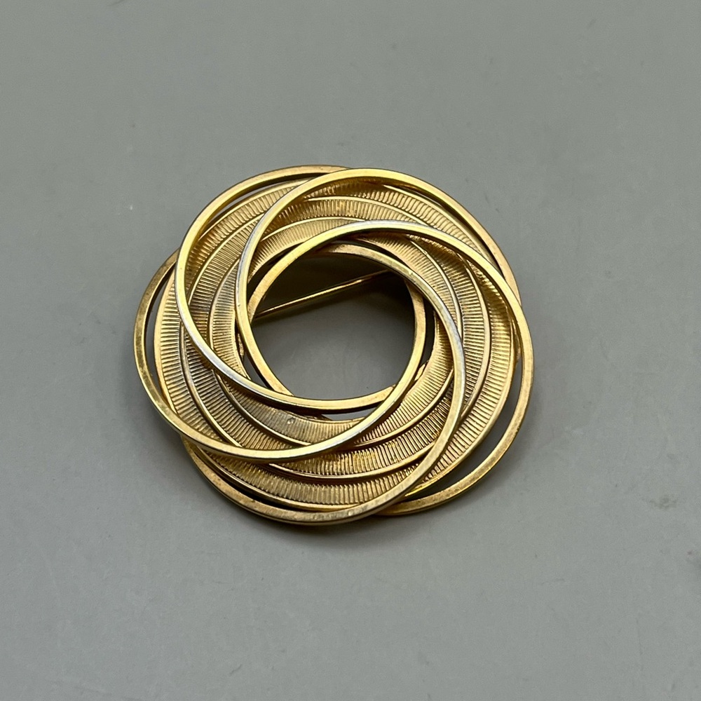 Gold Spiral Brooch with Intricate Design